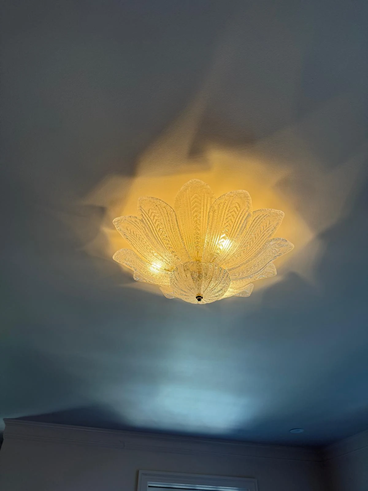 Glass flush-mount ceiling light fixture installed in a Los Angeles home